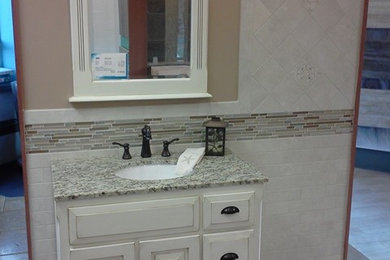 Inspiration for a transitional beige tile and porcelain tile bathroom remodel in Philadelphia with an undermount sink, raised-panel cabinets, beige cabinets and granite countertops