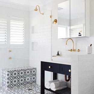 Inspiration for a 3/4 bathroom in Other with shaker cabinets, black cabinets, a corner shower, white tile, white walls, ceramic floors, a vessel sink and white benchtops.