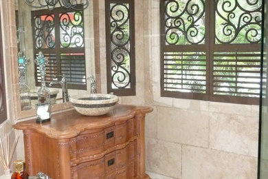 Ornate beige tile and ceramic tile corner shower photo in Vancouver with furniture-like cabinets, light wood cabinets, wood countertops and a hinged shower door