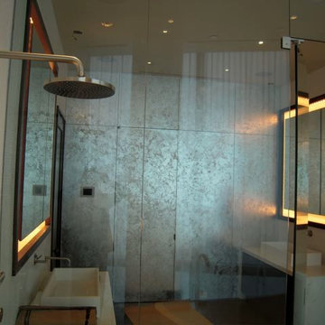 Silver leaf flakes applied to an accent wall in a bathroom with water proof seal