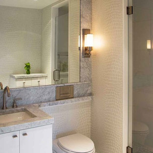 Alcove shower - mid-sized contemporary 3/4 gray tile marble floor alcove shower idea in Boston with an undermount sink, flat-panel cabinets, white cabinets, a wall-mount toilet and marble countertops