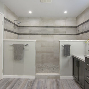 Inspiration for a mid-sized contemporary master gray tile and porcelain tile porcelain tile and gray floor bathroom remodel in San Diego with shaker cabinets, gray cabinets, a one-piece toilet, gray walls, an undermount sink and quartz countertops
