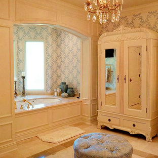 Photo of a large victorian master bathroom in New Orleans with an undermount sink, white cabinets and marble floors.