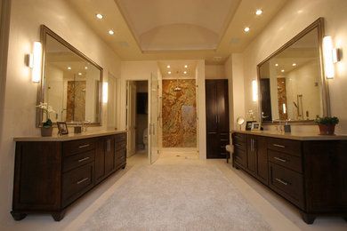 Example of a trendy beige floor bathroom design in Dallas with shaker cabinets, dark wood cabinets, beige walls, quartz countertops and beige countertops