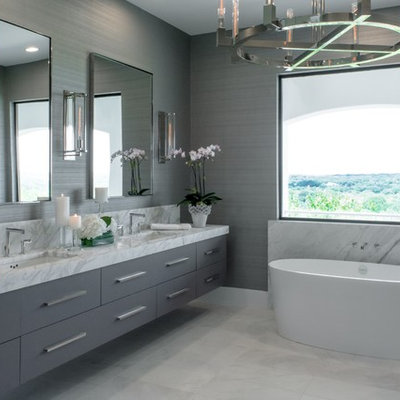 Inspiration for a contemporary gray tile gray floor freestanding bathtub remodel in Austin with flat-panel cabinets, gray cabinets, gray walls and an undermount sink