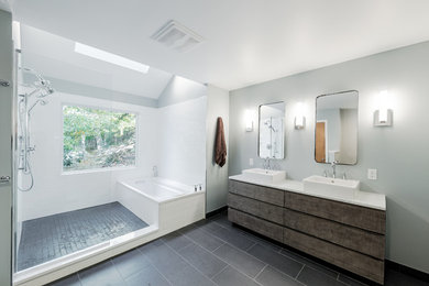 Bathroom - large contemporary master white tile and subway tile ceramic tile and gray floor bathroom idea in New York with furniture-like cabinets, a two-piece toilet, gray walls, a vessel sink, distressed cabinets and solid surface countertops