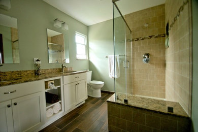 Example of a mid-sized transitional master beige tile and ceramic tile ceramic tile corner shower design in Columbus with an undermount sink, shaker cabinets, white cabinets, granite countertops and green walls
