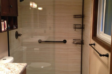 Example of a small classic master beige tile and ceramic tile porcelain tile alcove shower design in Portland with shaker cabinets, medium tone wood cabinets, a two-piece toilet and beige walls