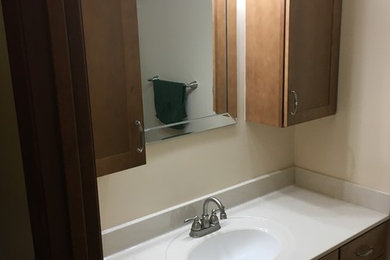 Small elegant porcelain tile and beige floor bathroom photo in Other with shaker cabinets and medium tone wood cabinets