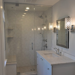 Photo of a mid-sized contemporary bathroom in New York with an undermount sink, furniture-like cabinets, white cabinets, engineered quartz benchtops, a two-piece toilet, multi-coloured tile, porcelain tile, grey walls, porcelain floors and with a sauna.
