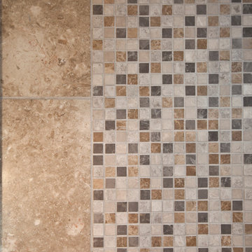 Small mosaic tiles bring all the colors from the spa-like master bathroom togeth
