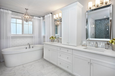 Large traditional ensuite bathroom in Edmonton with a submerged sink, shaker cabinets, white cabinets, quartz worktops, a freestanding bath, an alcove shower, grey walls, porcelain flooring, white tiles and metro tiles.