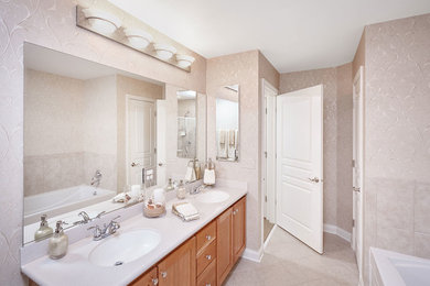 Example of a large classic master ceramic tile alcove bathtub design in Chicago with shaker cabinets, light wood cabinets, beige walls, an undermount sink and quartzite countertops
