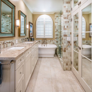 Beach style master beige tile and white tile beige floor bathroom photo in San Diego with recessed-panel cabinets, beige cabinets, beige walls, an undermount sink and beige countertops