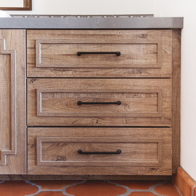 Example of a huge southwest master multicolored tile and ceramic tile terra-cotta tile and orange floor bathroom design in San Diego with raised-panel cabinets, medium tone wood cabinets, white walls, a vessel sink, a hinged shower door and gray countertops