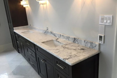 Inspiration for a mid-sized transitional master ceramic tile bathroom remodel in Dallas with recessed-panel cabinets, black cabinets, white walls, an undermount sink and marble countertops