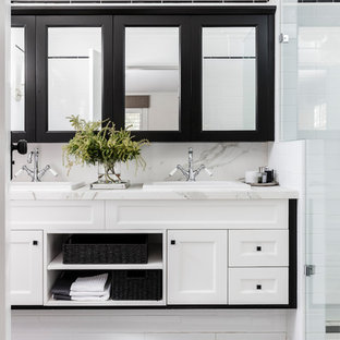 Inspiration for a transitional 3/4 bathroom in Sydney with shaker cabinets, white cabinets, white tile, subway tile, white walls, a drop-in sink, marble benchtops and black floor.