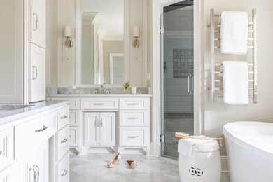 Bathroom - large traditional master porcelain tile, gray floor and single-sink bathroom idea in Atlanta with shaker cabinets, white cabinets, beige walls, an undermount sink, quartz countertops, a hinged shower door, gray countertops and a built-in vanity