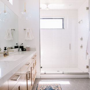 Wet room - large modern master porcelain tile and gray floor wet room idea in Salt Lake City with shaker cabinets, light wood cabinets, white walls, an undermount sink, quartz countertops, a hinged shower door and white countertops