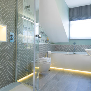 This is an example of a medium sized contemporary bathroom in Other with a wall mounted toilet, grey tiles, grey floors, a built-in bath, a corner shower and ceramic tiles.