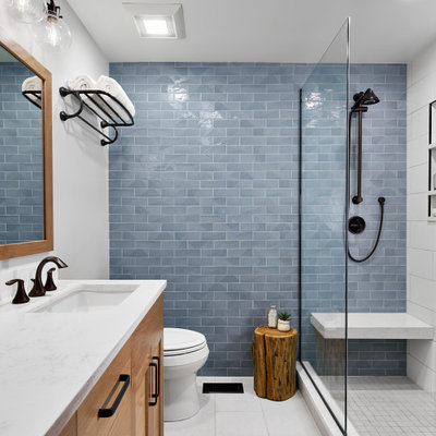 Transitional blue tile white floor bathroom photo in Chicago with light wood cabinets, white walls and white countertops