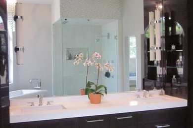 Inspiration for a large contemporary ensuite bathroom in Orlando with flat-panel cabinets, brown cabinets, a freestanding bath, multi-coloured tiles, marble tiles, grey walls, marble flooring, engineered stone worktops, white floors and white worktops.