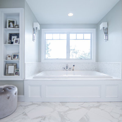 Inspiration for a large rustic master white tile and stone tile marble floor and white floor drop-in bathtub remodel in DC Metro with raised-panel cabinets, white cabinets, gray walls, an undermount sink, marble countertops and white countertops