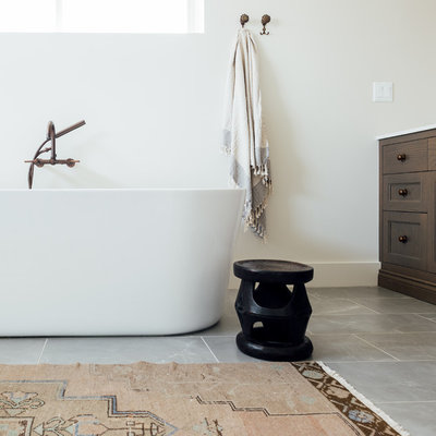 Large eclectic master white tile and ceramic tile porcelain tile and white floor bathroom photo in Salt Lake City with flat-panel cabinets, dark wood cabinets, a one-piece toilet, white walls, an integrated sink, solid surface countertops, a hinged shower door and white countertops
