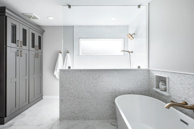 Inspiration for a medium sized modern ensuite bathroom in Tampa with shaker cabinets, grey cabinets, a freestanding bath, a walk-in shower, a two-piece toilet, white tiles, porcelain tiles, grey walls, porcelain flooring, a submerged sink, engineered stone worktops, white floors, an open shower and white worktops.