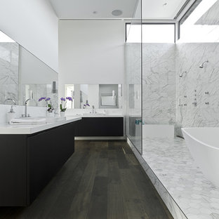 Example of a trendy white tile bathroom design in Houston with a drop-in sink, flat-panel cabinets and black cabinets