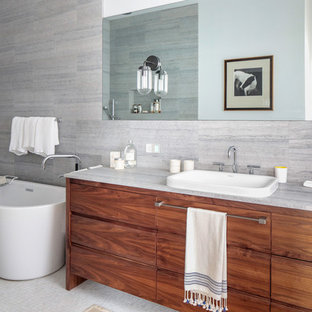 Bathroom - mid-sized contemporary master white tile and mosaic tile bathroom idea in New York with flat-panel cabinets, white cabinets, a one-piece toilet, gray walls, an undermount sink, marble countertops, a hinged shower door and white countertops