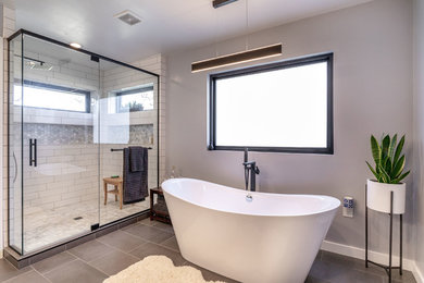 Mid-sized trendy master white tile and subway tile ceramic tile and gray floor bathroom photo in Other with flat-panel cabinets, dark wood cabinets, a one-piece toilet, gray walls, an undermount sink, quartz countertops, a hinged shower door and white countertops