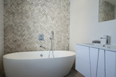Design ideas for a contemporary bathroom in Cardiff with a freestanding bath, mosaic tiles and white walls.