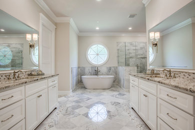 Inspiration for a large transitional master gray tile, white tile and marble tile marble floor and green floor bathroom remodel in Dallas with recessed-panel cabinets, white cabinets, beige walls, an undermount sink, granite countertops, a hinged shower door and brown countertops