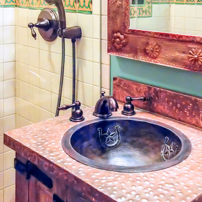 Mid-sized southwest master multicolored tile, white tile and mosaic tile terra-cotta tile and brown floor alcove shower photo in San Francisco with furniture-like cabinets, distressed cabinets, blue walls, a drop-in sink, copper countertops and a hinged shower door