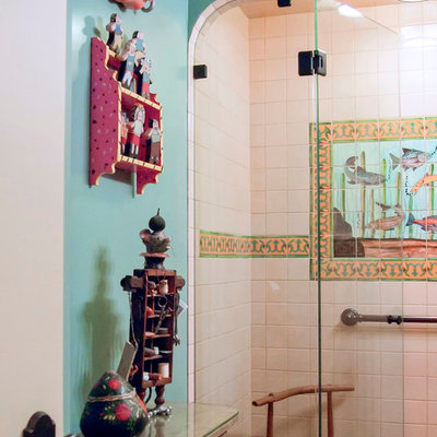 Alcove shower - mid-sized southwestern master multicolored tile, white tile and mosaic tile terra-cotta tile and brown floor alcove shower idea in San Francisco with furniture-like cabinets, blue walls and a hinged shower door