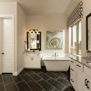 Bathroom - huge southwestern master white tile and subway tile porcelain tile, black floor and double-sink bathroom idea in Houston with shaker cabinets, white cabinets, beige walls, an undermount sink, granite countertops, a hinged shower door, gray countertops and a built-in vanity