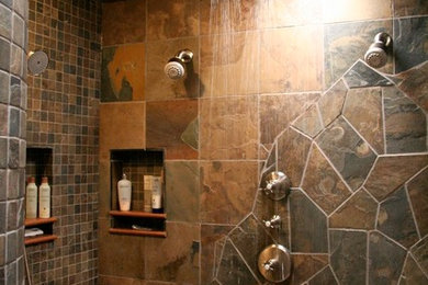 Example of a mid-sized southwest master beige tile, black tile, brown tile, gray tile and mosaic tile slate floor alcove shower design in Denver with flat-panel cabinets, black cabinets, beige walls, a drop-in sink and quartzite countertops