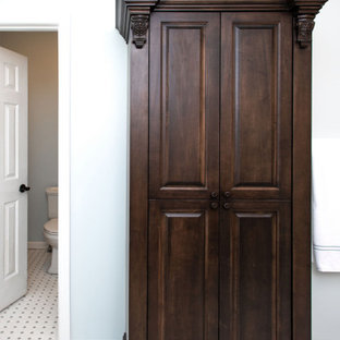 Inspiration for a large victorian master white tile and ceramic tile porcelain tile, multicolored floor and single-sink bathroom remodel in Other with recessed-panel cabinets, dark wood cabinets, a two-piece toilet, blue walls, an undermount sink, quartz countertops, a hinged shower door, white countertops and a freestanding vanity