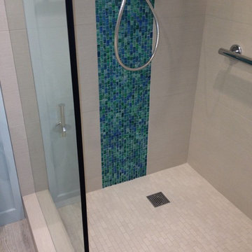 Spa doorless shower with glass tile accent
