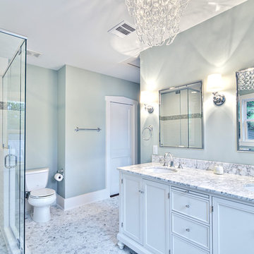 Spa-like master bath with glass chandelier and pedestal tub
