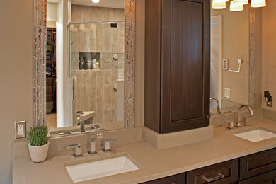 Transitional master gray tile corner shower photo in Milwaukee with an undermount sink, flat-panel cabinets, medium tone wood cabinets and quartz countertops
