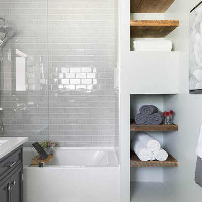 Example of a mid-sized danish 3/4 white tile and ceramic tile mosaic tile floor and multicolored floor bathroom design in Chicago with raised-panel cabinets, a two-piece toilet, white walls, a drop-in sink, soapstone countertops and gray cabinets