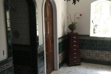 Inspiration for a mediterranean ensuite bathroom in Los Angeles with an alcove shower, a one-piece toilet, green tiles, ceramic tiles and ceramic flooring.
