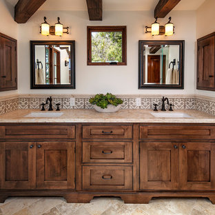 Design ideas for a large mediterranean ensuite bathroom in Santa Barbara with a submerged sink, recessed-panel cabinets, medium wood cabinets, a freestanding bath, a walk-in shower, beige tiles, ceramic tiles and beige walls.