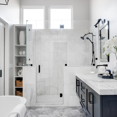 Example of a mid-sized beach style master white tile and marble tile gray floor and marble floor bathroom design in Los Angeles with shaker cabinets, white walls, a hinged shower door, white countertops, blue cabinets, a two-piece toilet, an undermount sink and quartz countertops