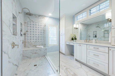 Inspiration for a large transitional master multicolored tile and porcelain tile marble floor, multicolored floor and double-sink bathroom remodel in Orlando with recessed-panel cabinets, beige cabinets, a two-piece toilet, blue walls, an undermount sink, quartzite countertops, white countertops and a built-in vanity