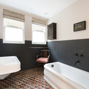 Photo of a classic ensuite bathroom in London with black tiles, mosaic tiles, white walls, mosaic tile flooring, a wall-mounted sink and multi-coloured floors.