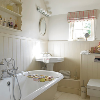 Inspiration for a shabby-chic style claw-foot bathtub remodel in Wiltshire with a wall-mount toilet, beige walls and a pedestal sink