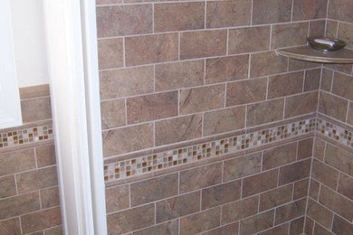 Example of a small transitional 3/4 multicolored tile and ceramic tile bathroom design in New York